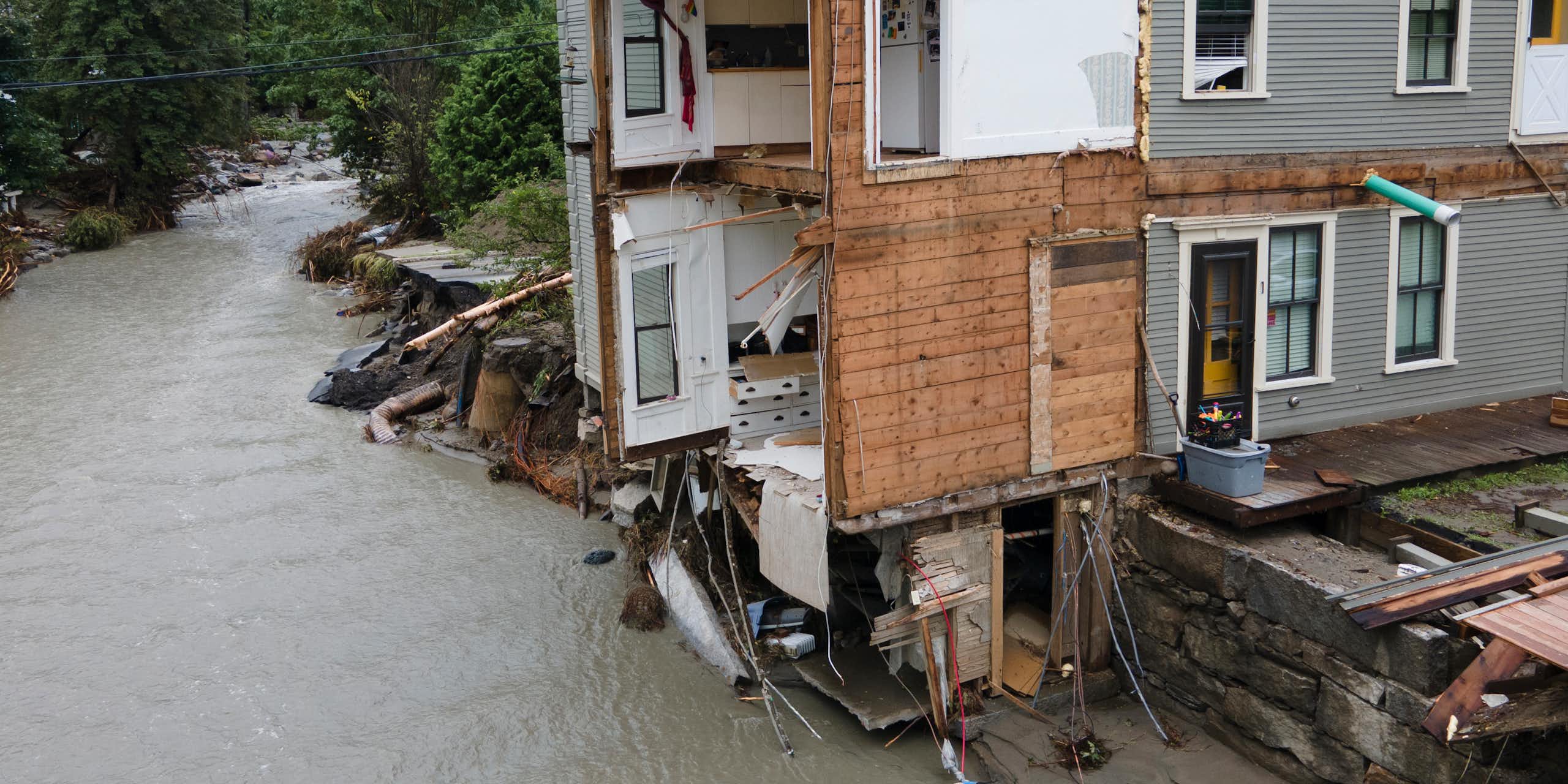 The front of an eight-unit apartment building is torn off.