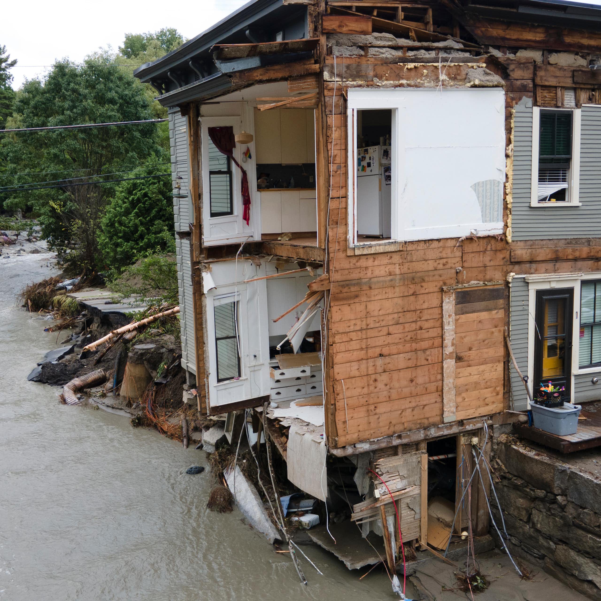 The front of an eight-unit apartment building is torn off.