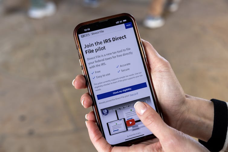 An IRS app is seen on a smartphone held by someone with nice nails.