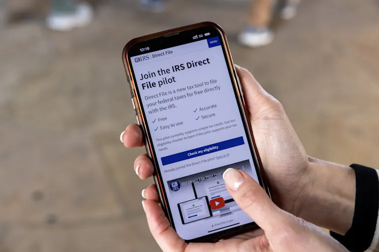 An IRS app is seen on a smartphone held by someone with nice nails.
