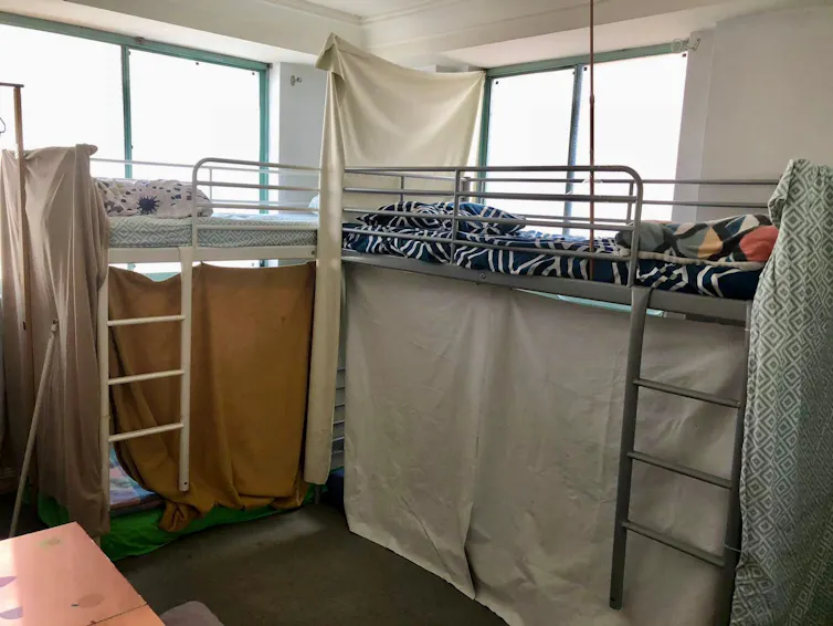 Curtains hang over the rails of a bunk bed in a shared bedroom in Sydney