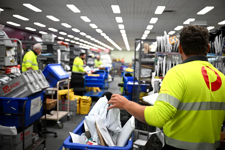 Australia Post workers sorting mail for delivery