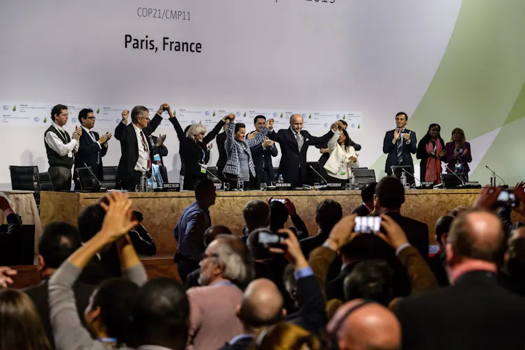 people celebrating after agreement signed