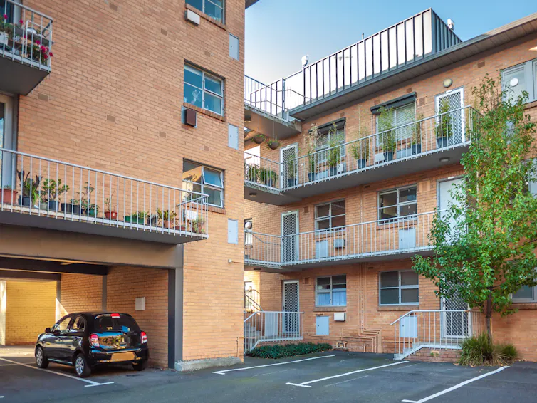 old apartment block with parking