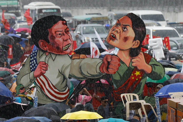 Cutouts of Ferdinand 'Bongbong' Marcos and Sara Duterte displayed during a protest in Manila, July 2024.