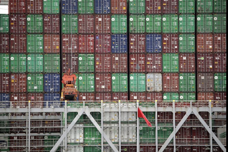 A large tower of multi-coloured cargo containers.