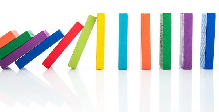 a chain of colorful dominos falling one by one
