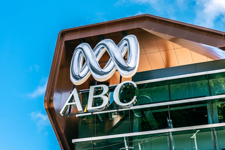 Top of a building featuring the ABC symbol against a blue sky.