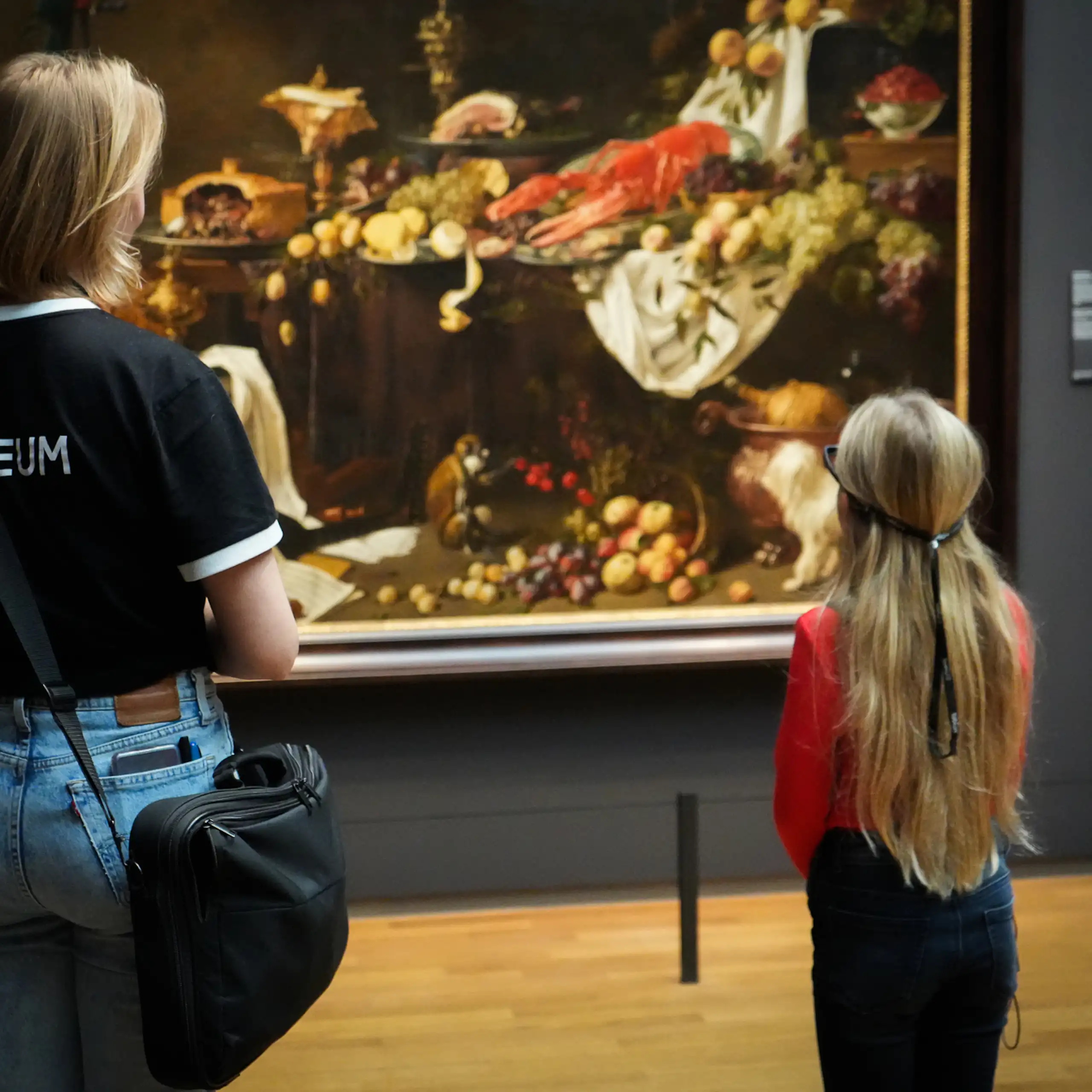 Adult and child looking at still life painting, child wearing glasses