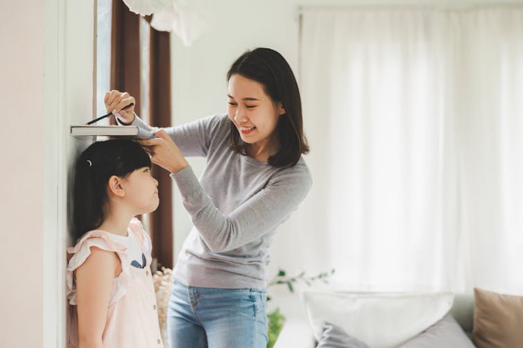 Mother measures child's height