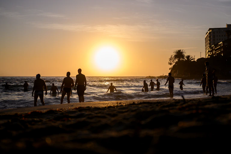 Beachgoers are seen during sunrise at Cronulla Beach in Sydney, Tuesday, November 26, 2024