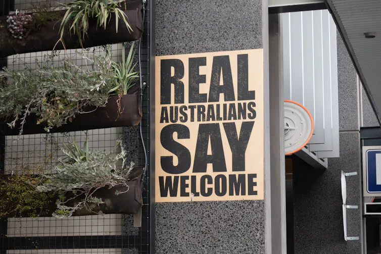 A sign that reads real Australians say welcome.