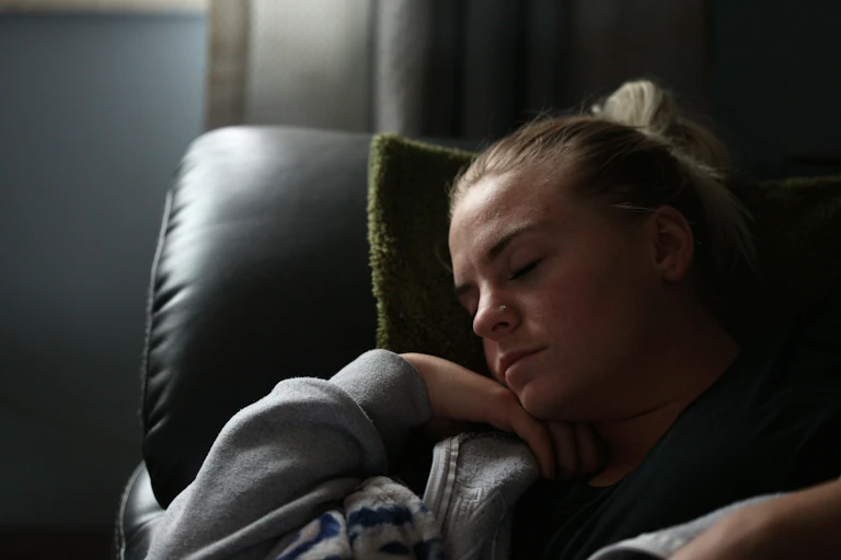 Woman rests on sofa