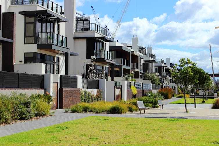 A row of modern townhouses on a residential street