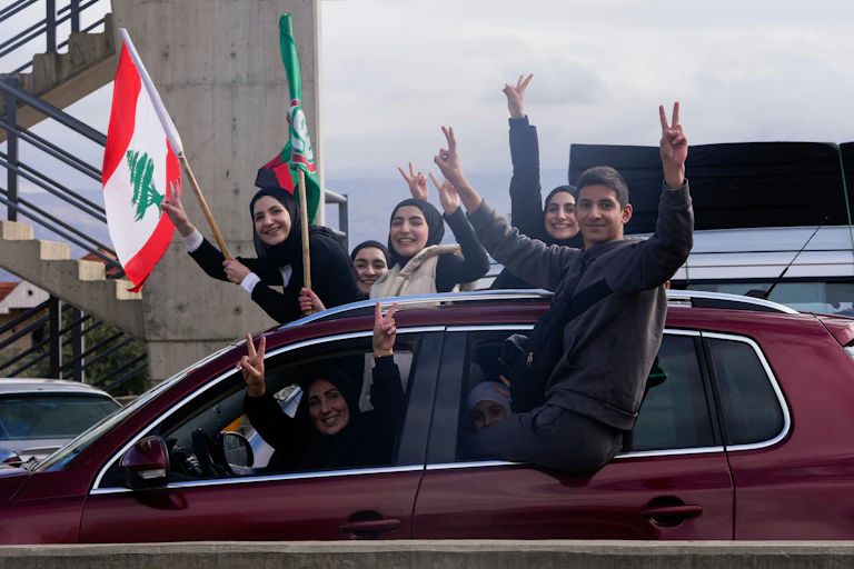 Young displaced Lebanese civilians celebrate news of the ceasefire.