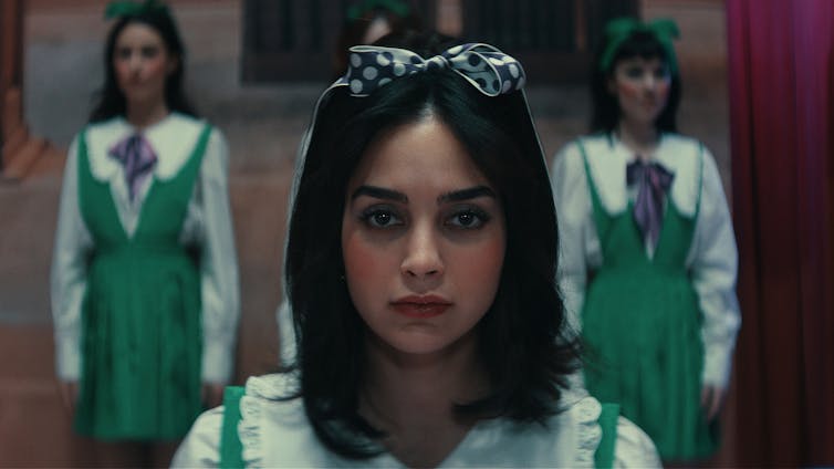 Melissa Barrera in a green dress with a bow in her hair