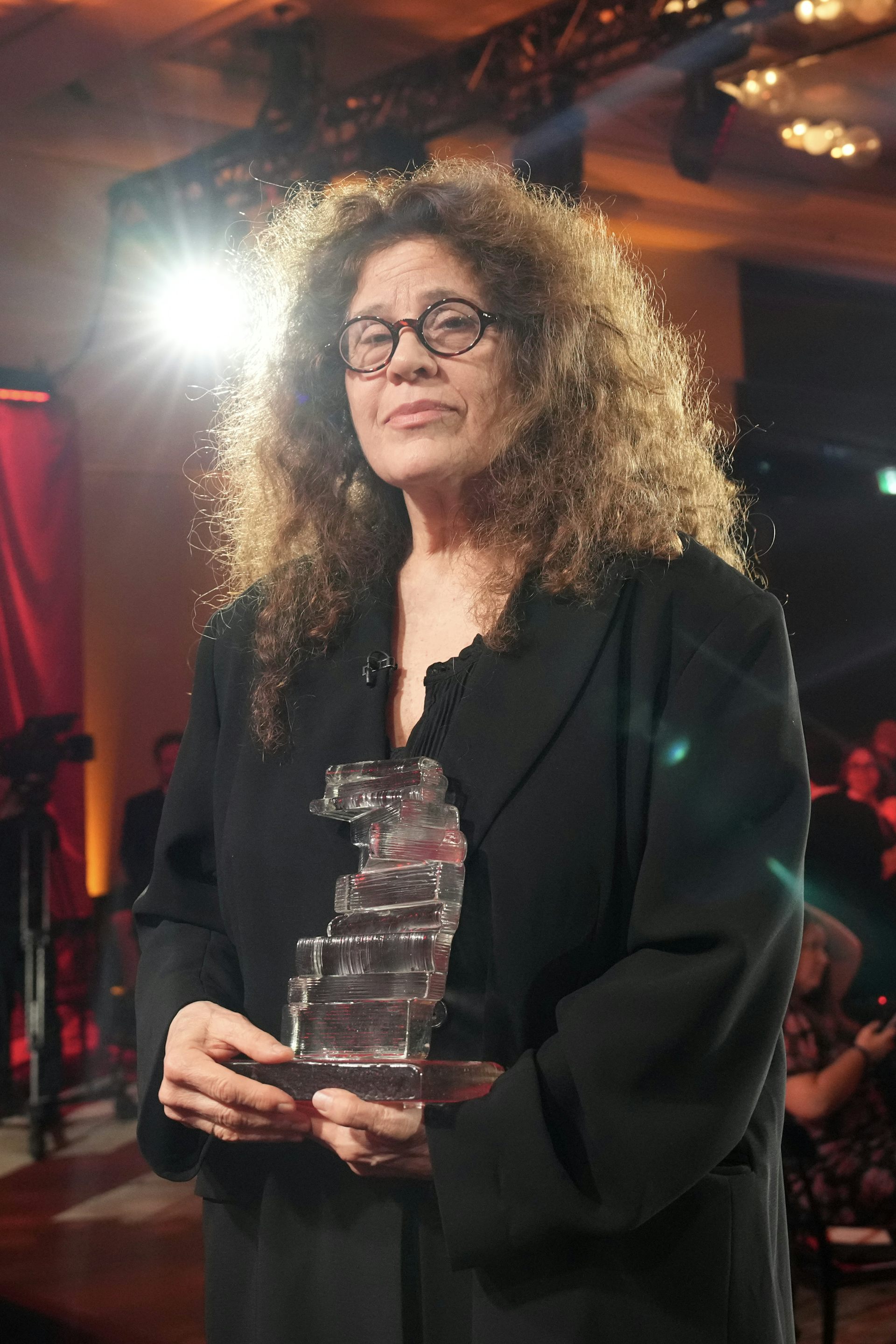 A woman holding an award.