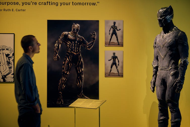 A man looks at a costume.