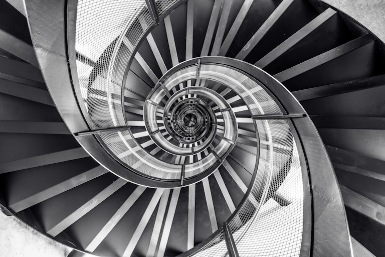 A black and white staircase spiralling.