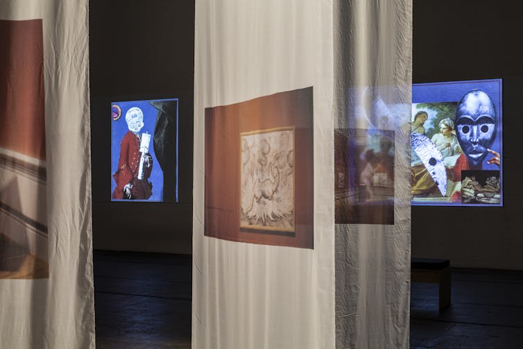 A room of images and projections in an exhibition space.