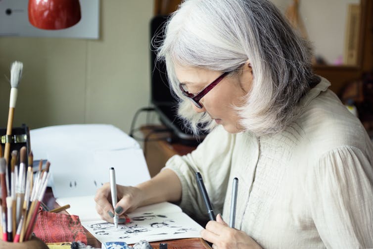 Woman drawing faces
