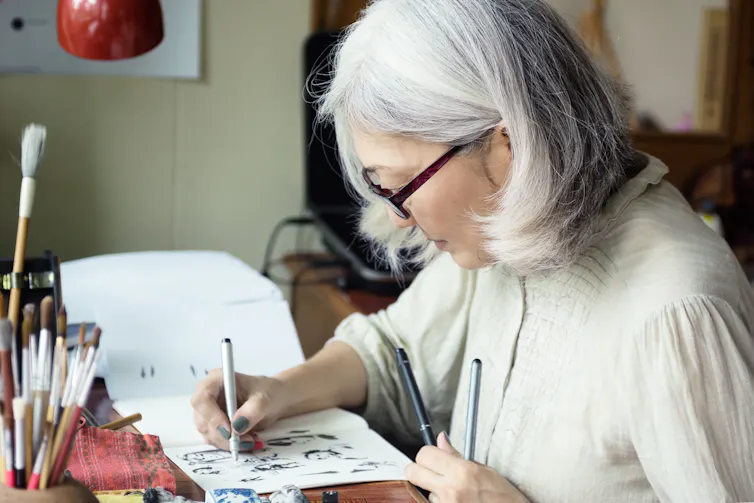 Woman drawing faces