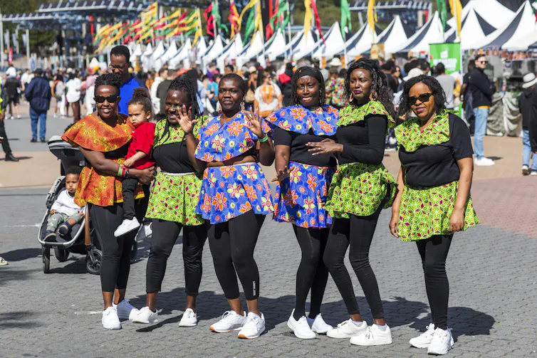 Six African women pose for a photo.