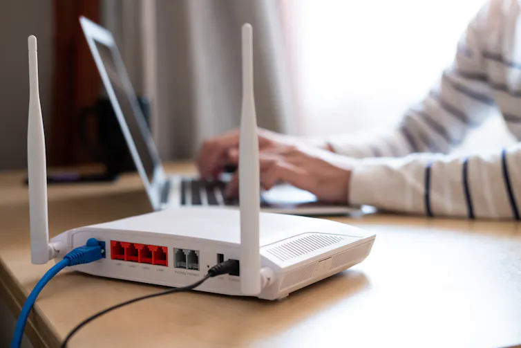 Internet router on working table with blurred man in background