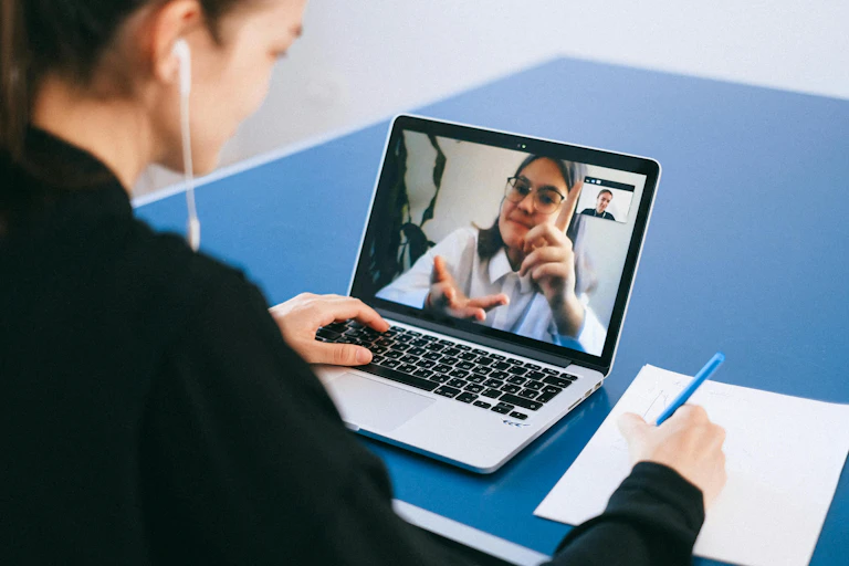 A woman is interviewed via a Zoom meeting.