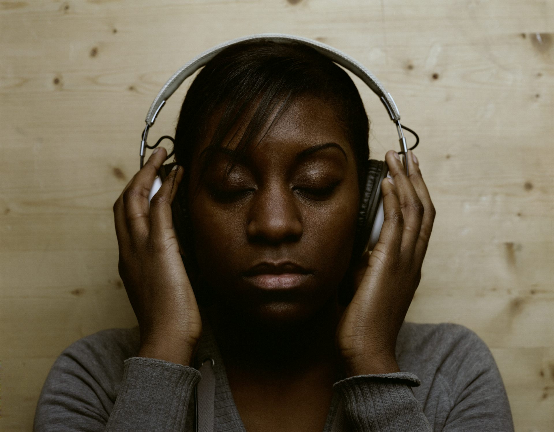 A Black woman with headphones.