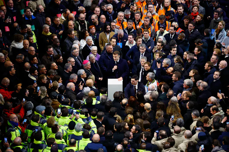 Macron talking to a crowd of people