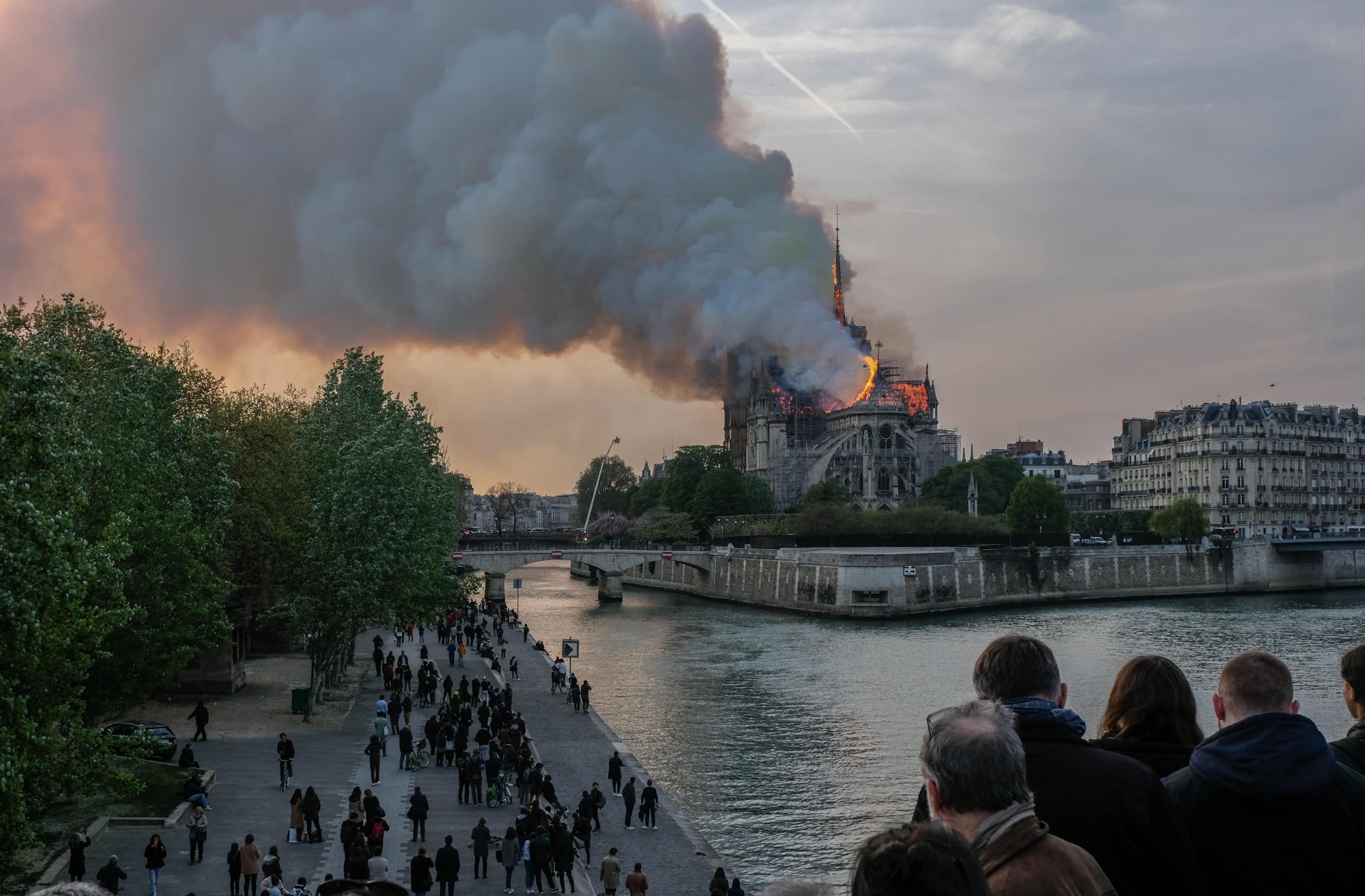 People watch Notre Dame Cathedral burn.