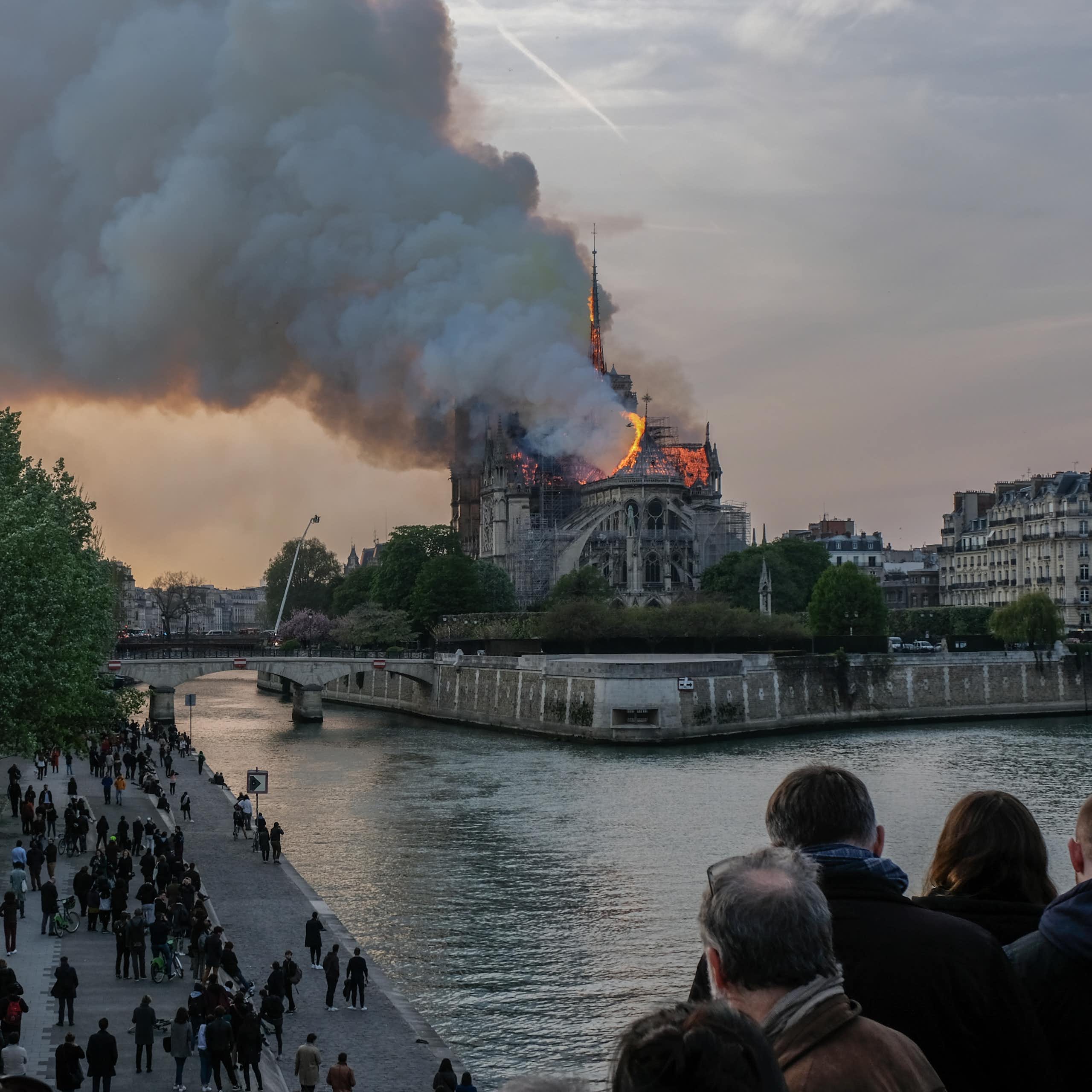 People watch Notre Dame Cathedral burn.