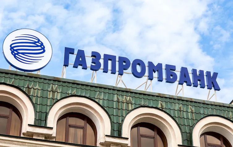 Signboard with the logo of Gazprombank against a blue sky.