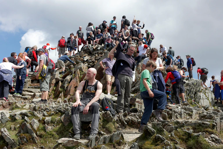 Huge crowds on the summit of a mountain.