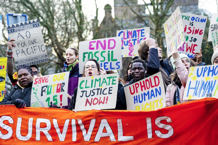 Climate justice protesters with signs