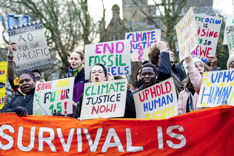 Climate justice protesters with signs