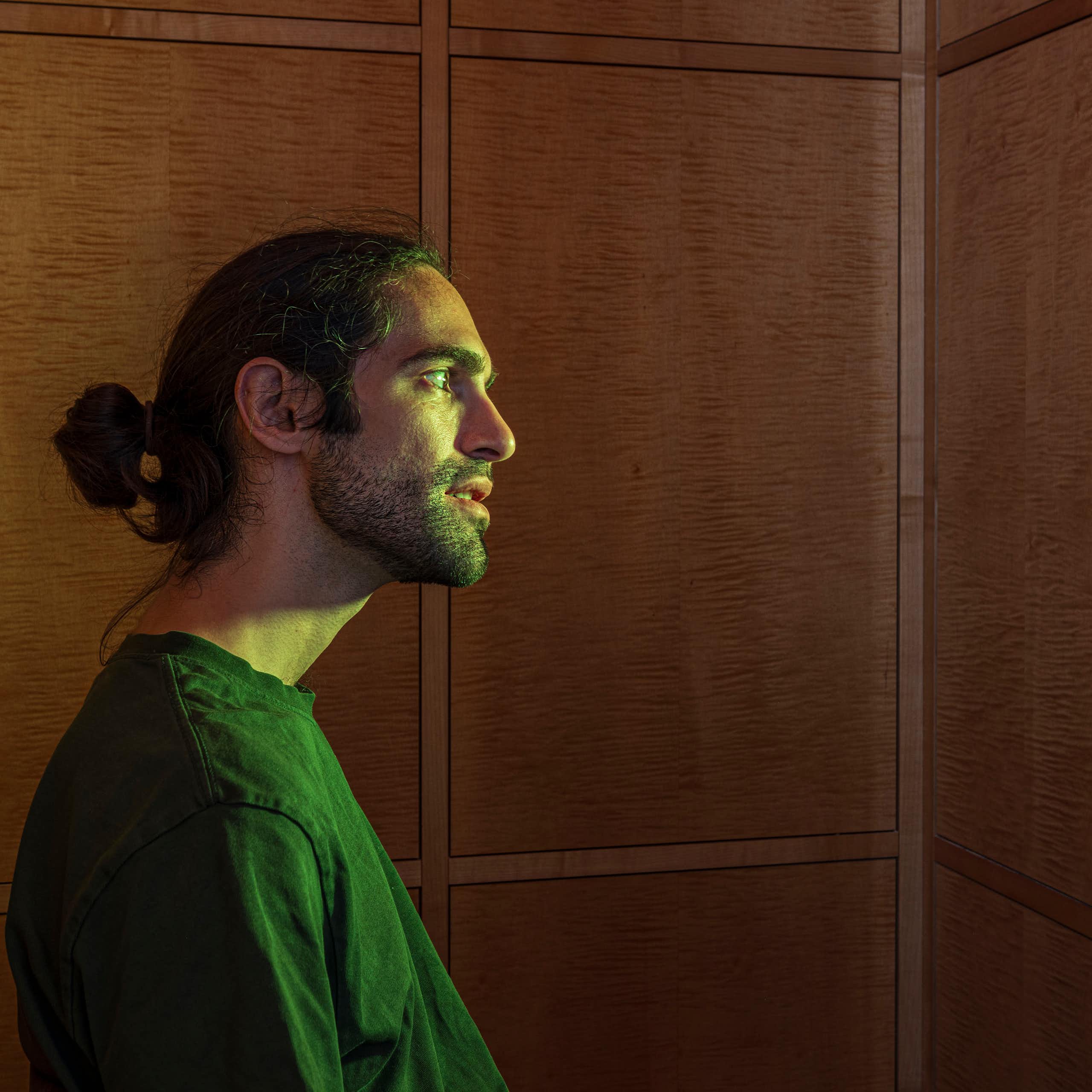 A hologram of an AI Jesus behind a latticework screen.