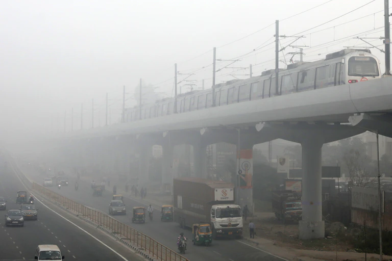 Metro train on elevated track disappears into smog