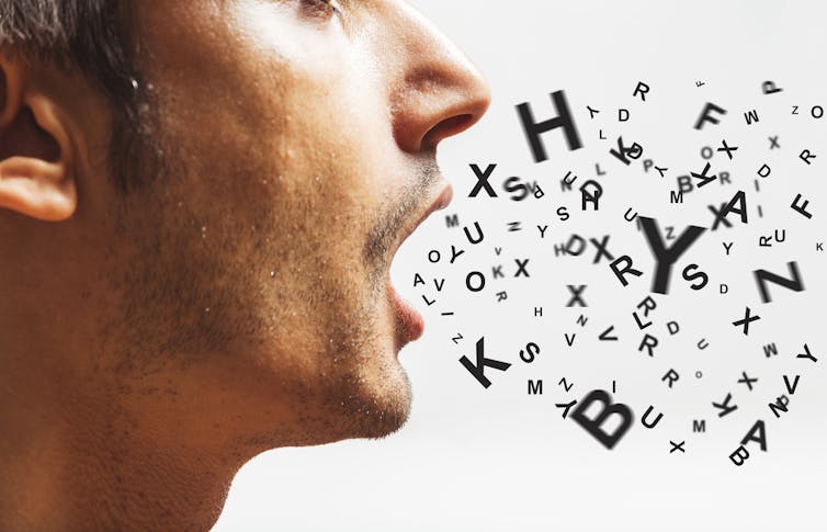 A man speaking, with letters coming out of his mouth.
