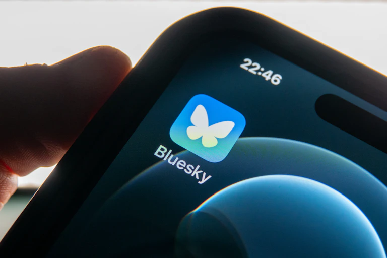 close-up of a smartphone screen with one icon and a person's thumb on the edge of the phone