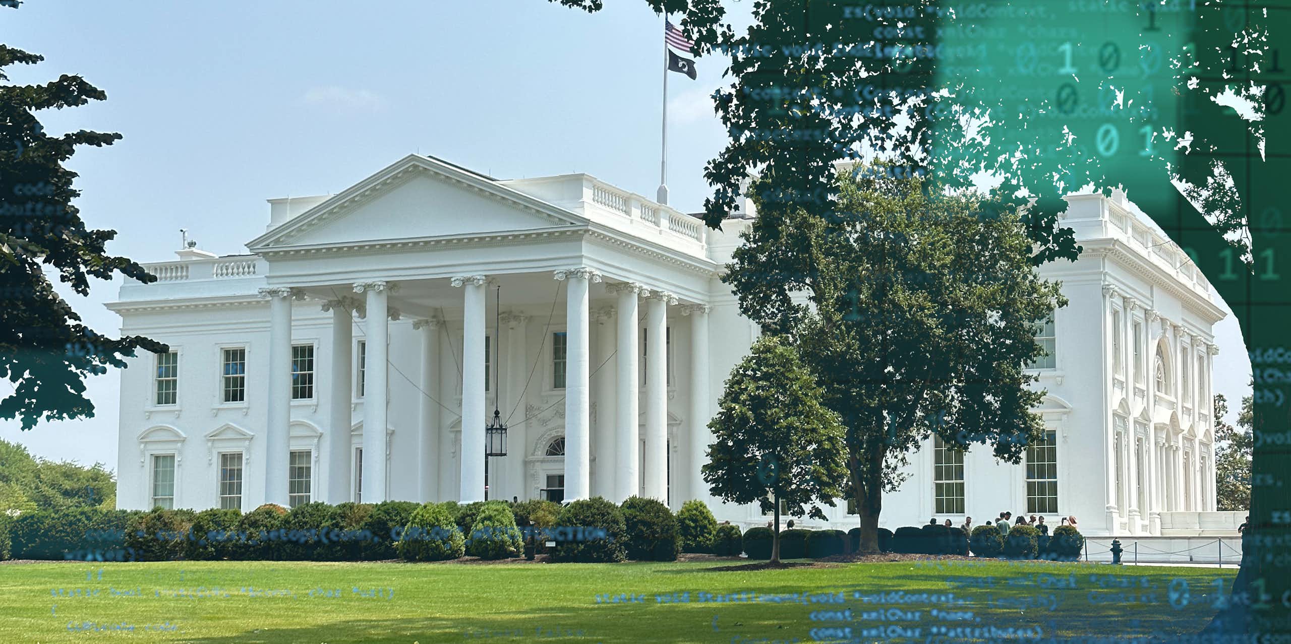 A large white, columned mansion surrounded by a lawn.