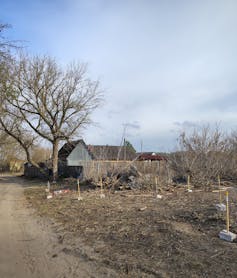Abandoned land next to a farmhouse.