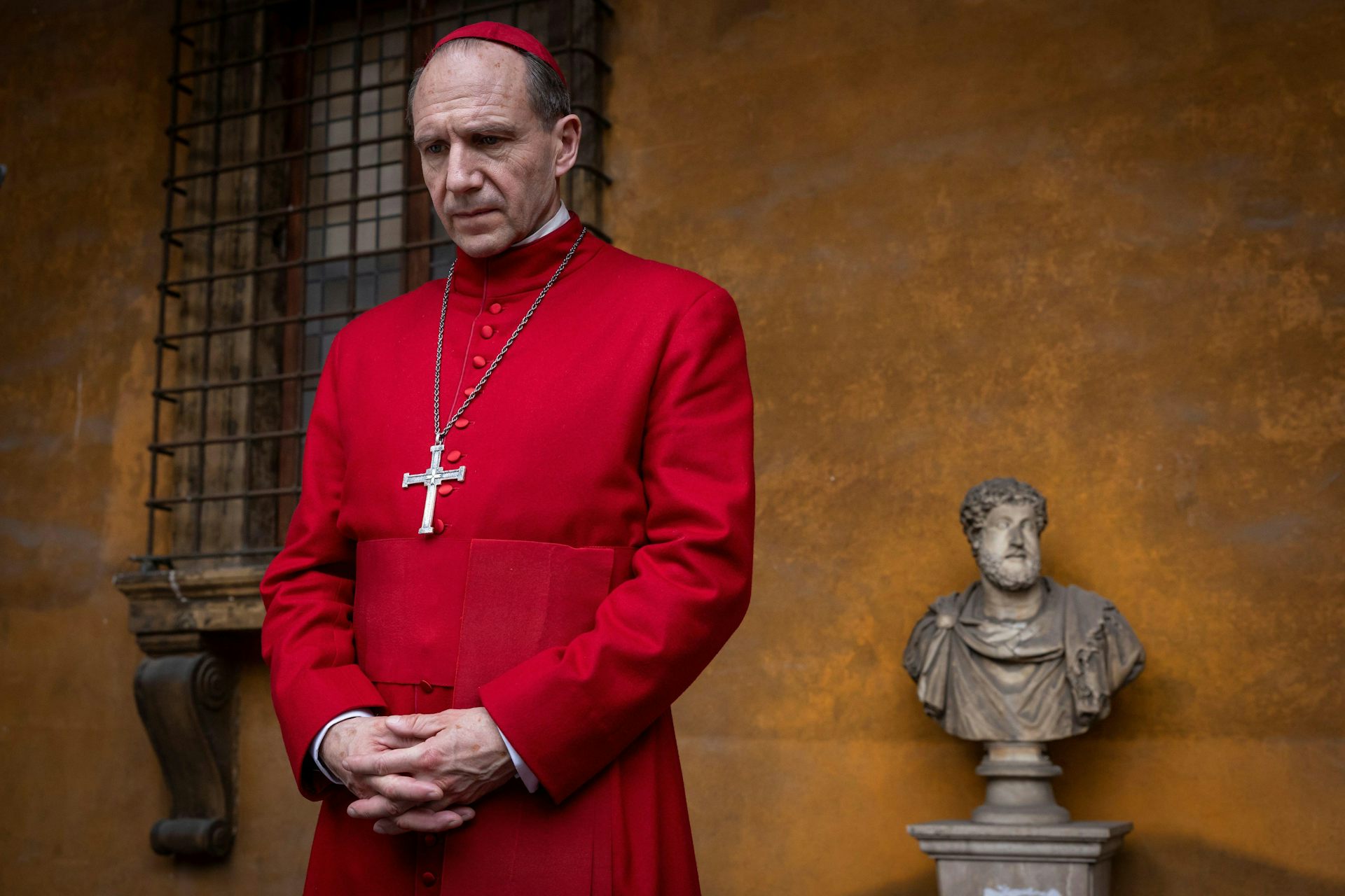 A cardinal dressed in scarlet robes in the Vatican.
