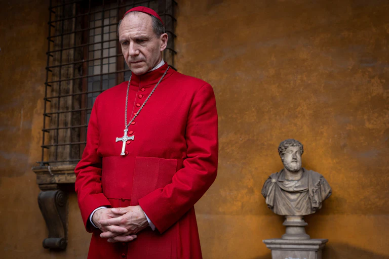 A cardinal dressed in scarlet robes in the Vatican.