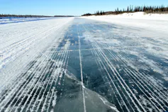 An icy surface is seen under a clear sky.