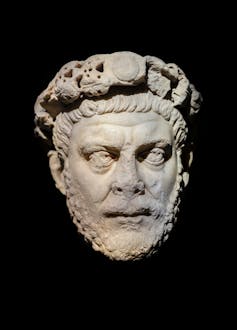 A marble statue depicts Emperor Diocletian.