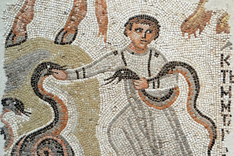 An ancient mosaic of a boy with two snakes