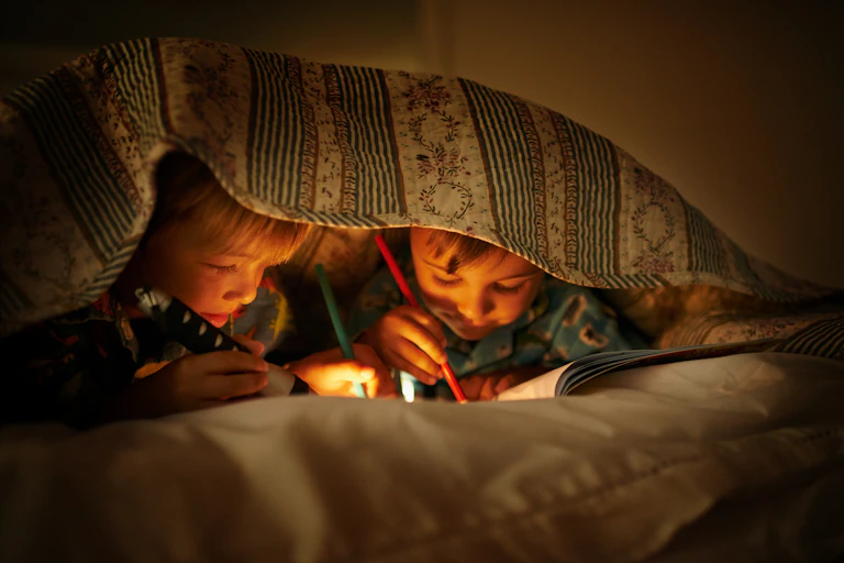 Kids colour in and draw while at a sleepover.