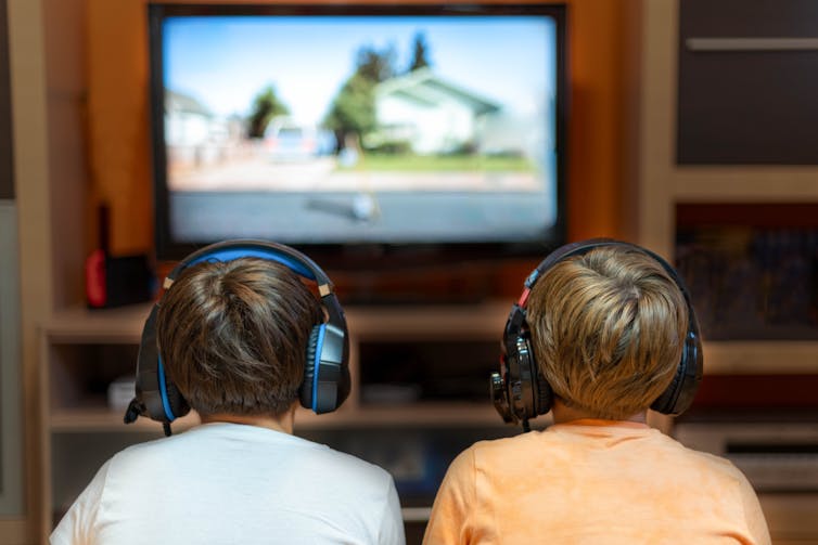 Two boys engage in online gaming.